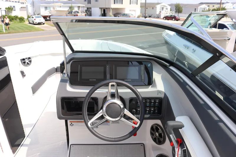 Slide: The Image of 2023 Regal LS6 boat dashboard with steering wheel and modern controls. - 7