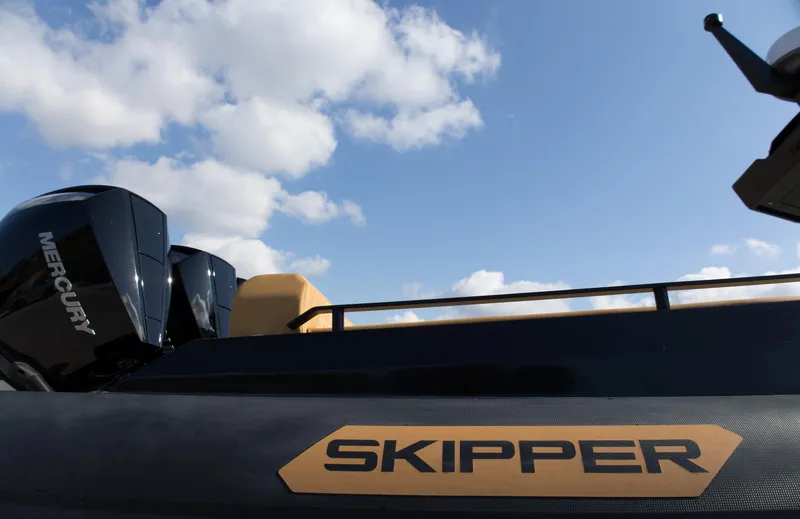 Slide: The Image of 2024 Skipper-BSK 38NC boat with Mercury engines under a blue sky. - 12