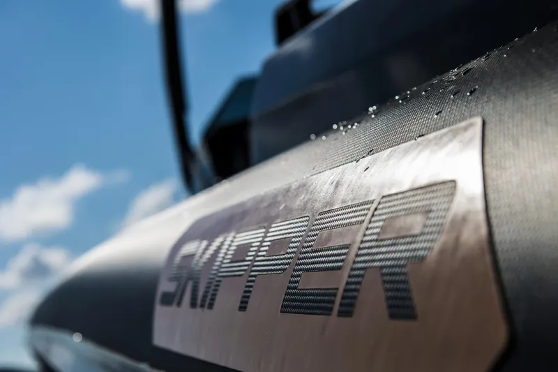 Slide: The Image of Close-up of Skipper-BSK 38NC boat logo with water droplets, 2024 model. - 14