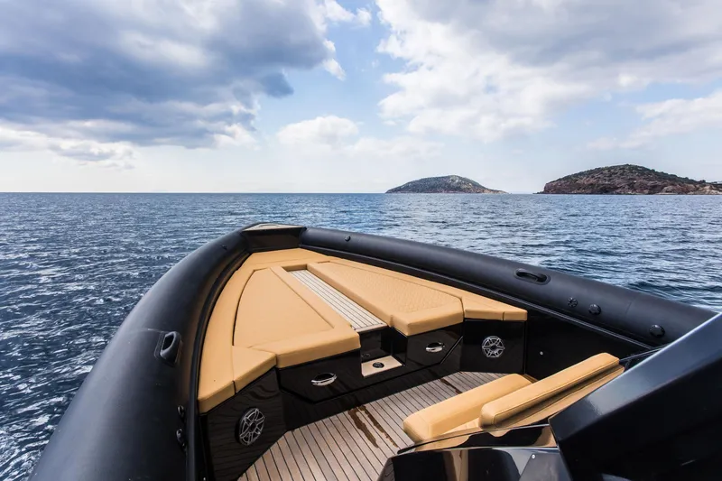 Slide: The Image of 2024 Skipper-BSK 38NC luxury boat on open sea with scenic island view. - 33