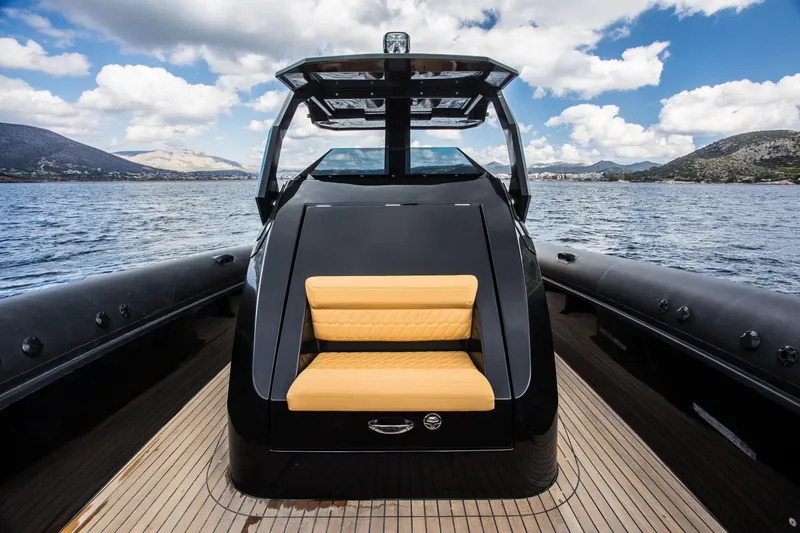 Slide: The Image of 2024 Skipper-BSK 38NC luxury boat with sleek black design and tan seating on open water. - 35
