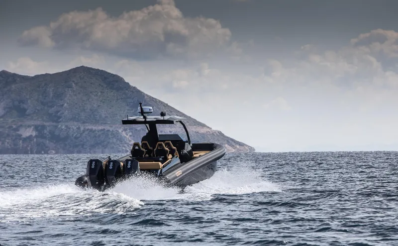 Slide: The Image of 2024 Skipper-BSK 38NC boat cruising on open water with mountainous background. - 6
