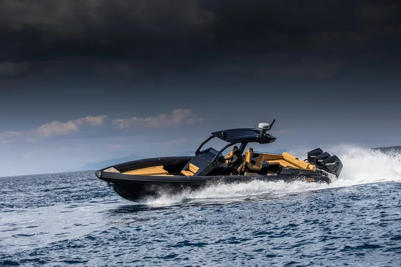 Slide: The Image of 2024 Skipper-BSK 38NC speedboat cruising on open water under a cloudy sky. - 1