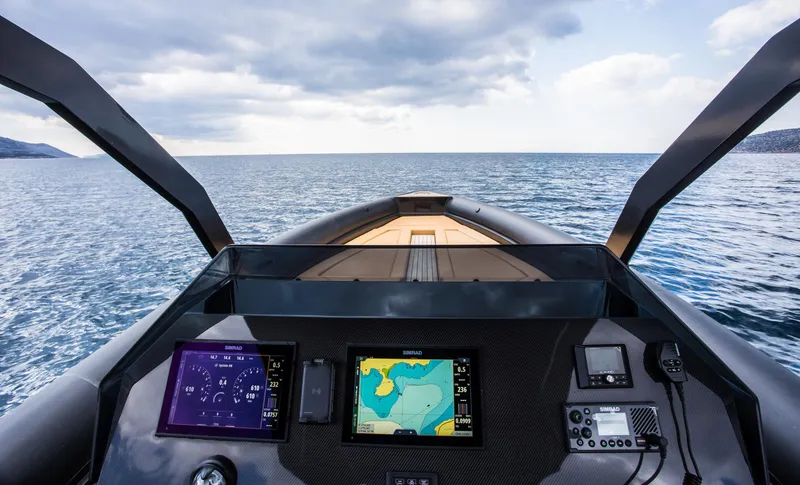 Slide: The Image of Cockpit view of 2024 Skipper-BSK 38NC boat with navigation screens on open water. - 34