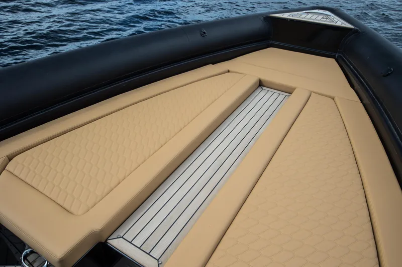 Slide: The Image of 2024 Skipper-BSK 38NC boat with tan cushioned deck on water. - 27