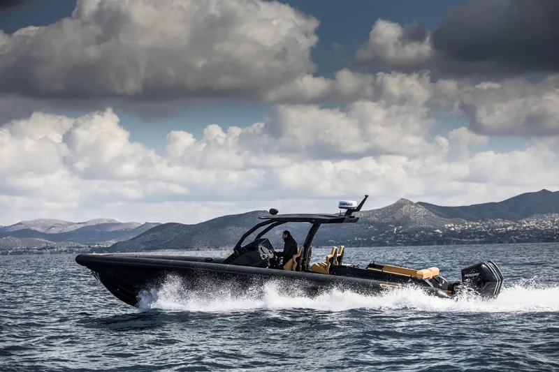 Slide: The Image of 2024 Skipper-BSK 38NC boat cruising on the water with mountains in the background. - 4