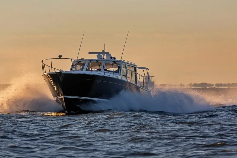 Slide: The Image of 2023 MJM 50z yacht cruising at sunset on open water. - 0