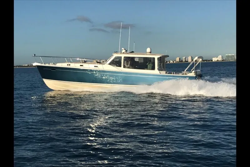 Slide: The Image of 2023 MJM 50z boat cruising on open water. - 1