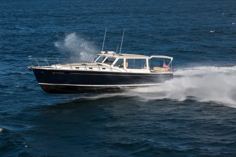 Slide: The Image of 2023 MJM 50z yacht cruising on open water. - 12