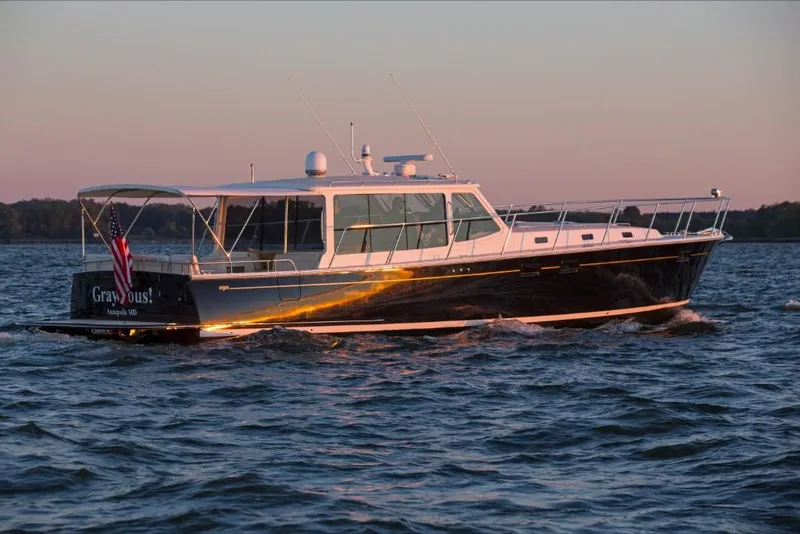 Slide: The Image of 2023 MJM 50z yacht cruising on water at sunset. - 13