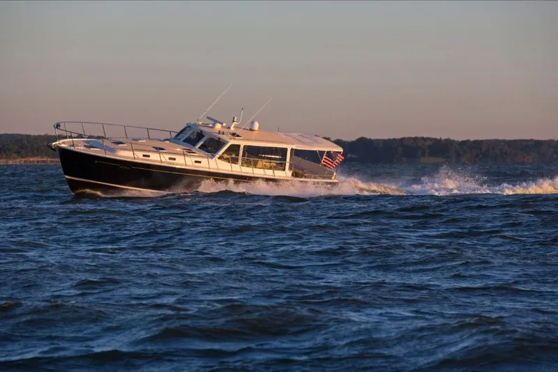 Slide: The Image of 2023 MJM 50z yacht cruising on open water at sunset. - 15