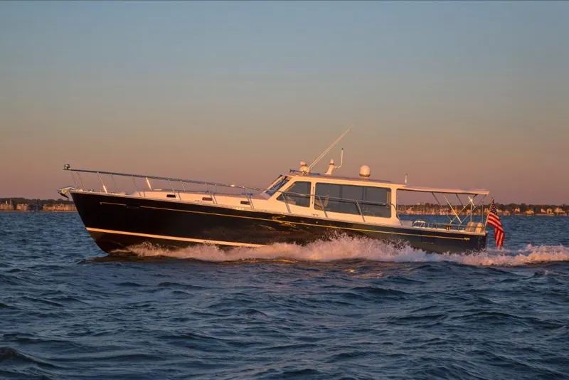 Slide: The Image of 2023 MJM 50z yacht cruising at sunset on open water. - 18