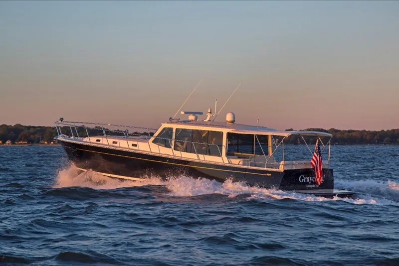 Slide: The Image of 2023 MJM 50z yacht cruising on open water at sunset. - 19