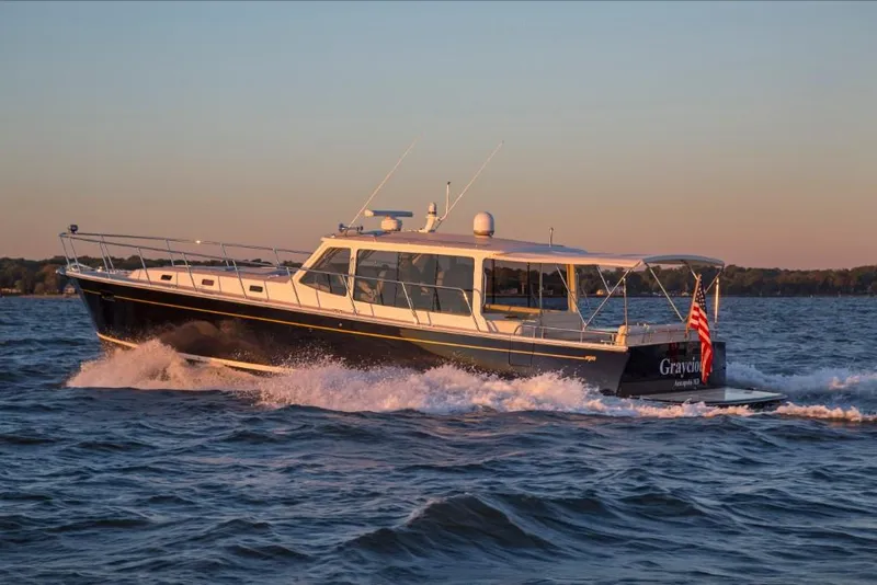 Slide: The Image of 2023 MJM 50z yacht cruising on open water at sunset. - 20