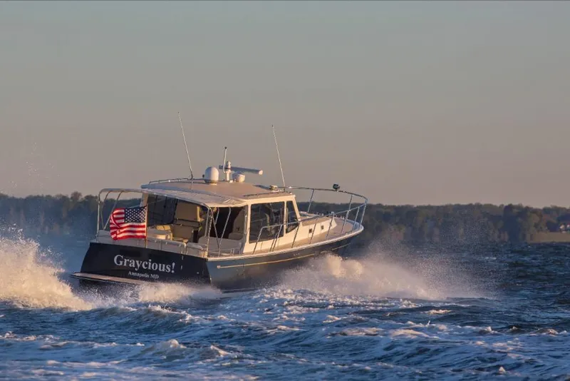 Slide: The Image of MJM 50z 2023 boat cruising on water with American flag. - 21