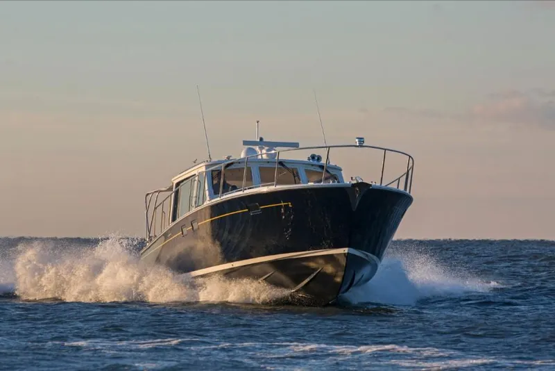 Slide: The Image of 2023 MJM 50z boat cruising on open water. - 23