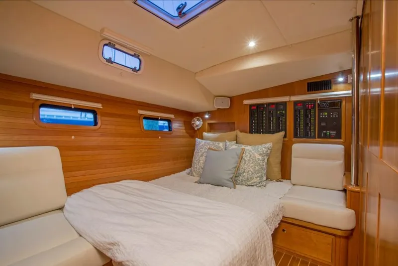 Slide: The Image of Luxurious cabin interior of 2023 MJM 50z yacht with cozy bed and wooden paneling. - 27