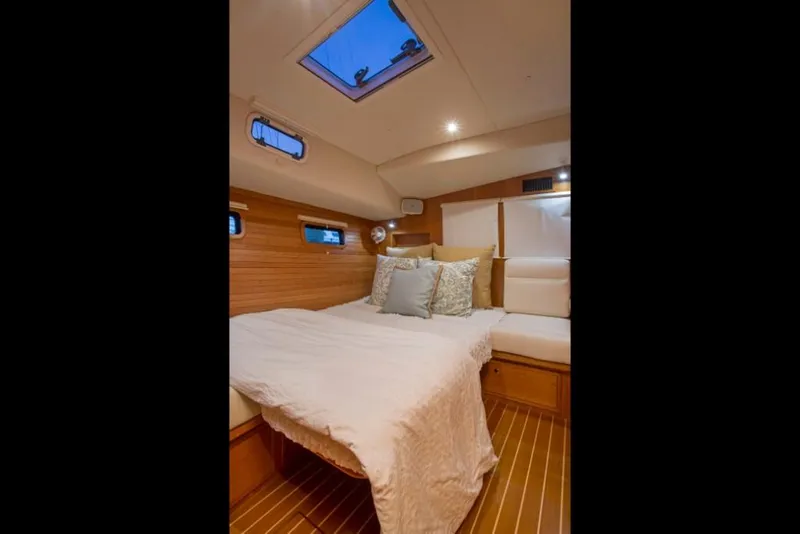 Slide: The Image of Luxurious cabin interior of 2023 MJM 50z yacht with cozy bed and wooden finish. - 29