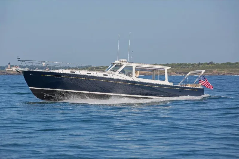 Slide: The Image of 2023 MJM 50z yacht cruising on open water. - 3