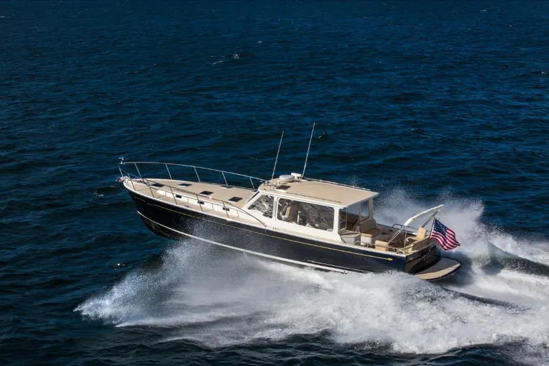 Slide: The Image of 2023 MJM 50z boat cruising on open water. - 9