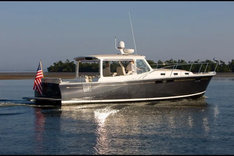 Slide: The Image of 2023 MJM 40z boat cruising on calm waters. - 1