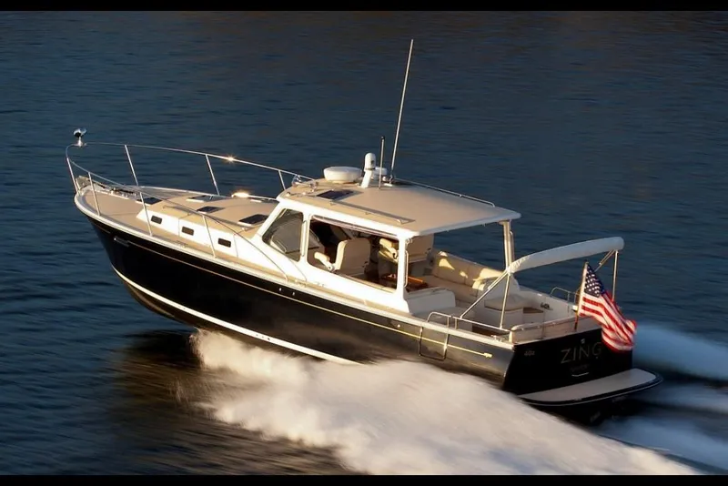 Slide: The Image of 2023 MJM 40z boat cruising on water. - 10