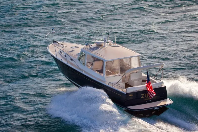 Slide: The Image of 2023 MJM 40z boat cruising on open water. - 11