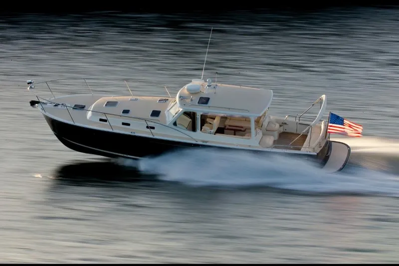 Slide: The Image of 2023 MJM 40z yacht cruising on water with American flag. - 13