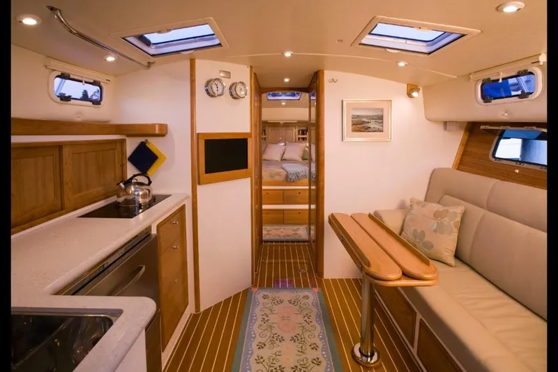 Slide: The Image of Interior of 2023 MJM 40z yacht with kitchen, seating area, and cozy bedroom. - 15