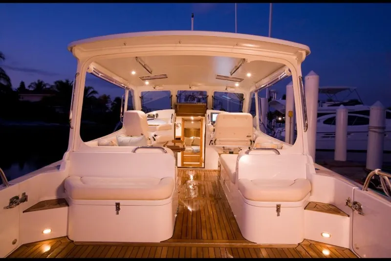 Slide: The Image of 2023 MJM 40z luxury yacht interior at dusk, featuring spacious seating and elegant lighting. - 16