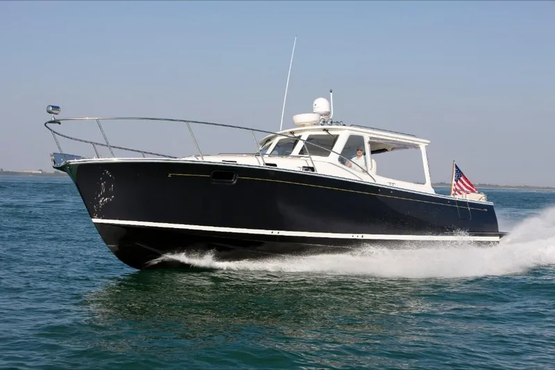 Slide: The Image of 2023 MJM 40z boat cruising on open water. - 2