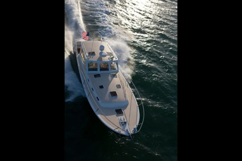 Slide: The Image of 2023 MJM 40z yacht cruising on open water. - 3