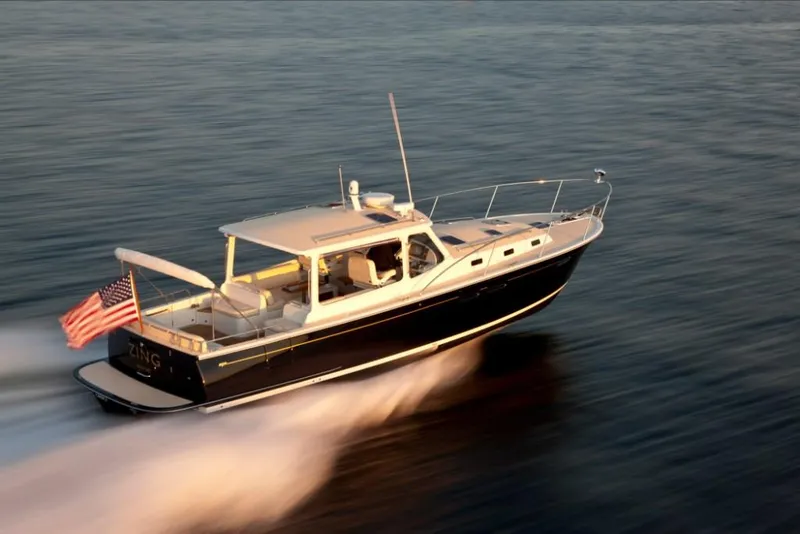 Slide: The Image of 2023 MJM 40z boat cruising on water at high speed. - 5