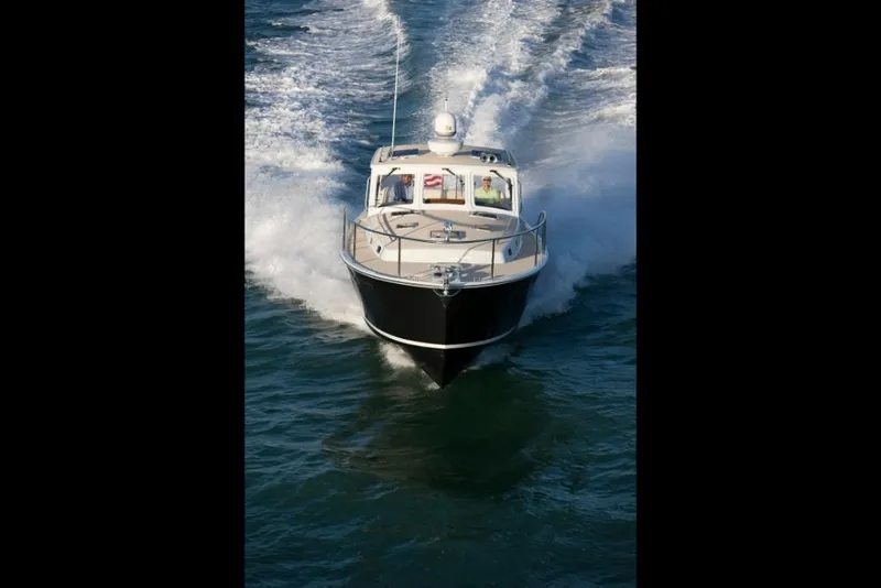 Slide: The Image of 2023 MJM 40z boat cruising on open water. - 7