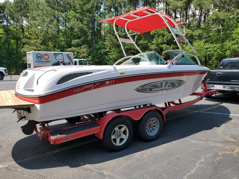 Slide: The Image of 2005 Correct Craft SV-211 Limited boat on trailer, parked outdoors. - 13