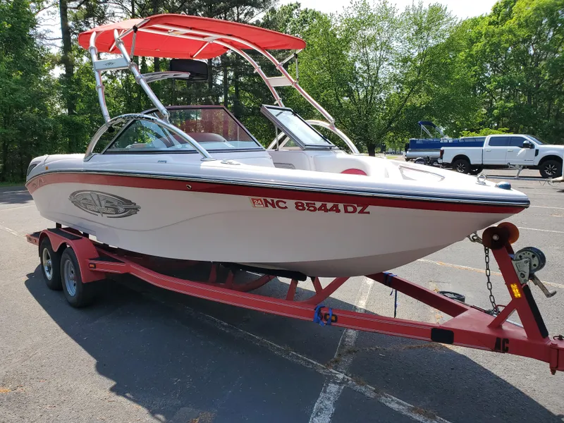 Slide: The Image of 2005 Correct Craft SV-211 Limited boat on red trailer in parking lot. - 14