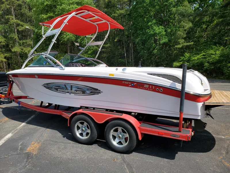 Slide: The Image of 2005 Correct Craft SV-211 Limited boat on red trailer, parked outdoors. - 15