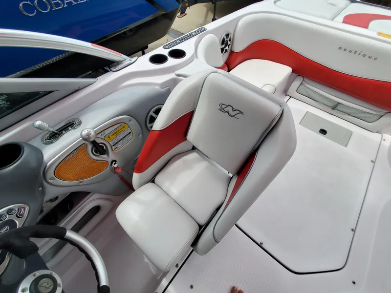 Slide: The Image of 2005 Correct Craft SV-211 Limited boat interior with white and red seating. - 17