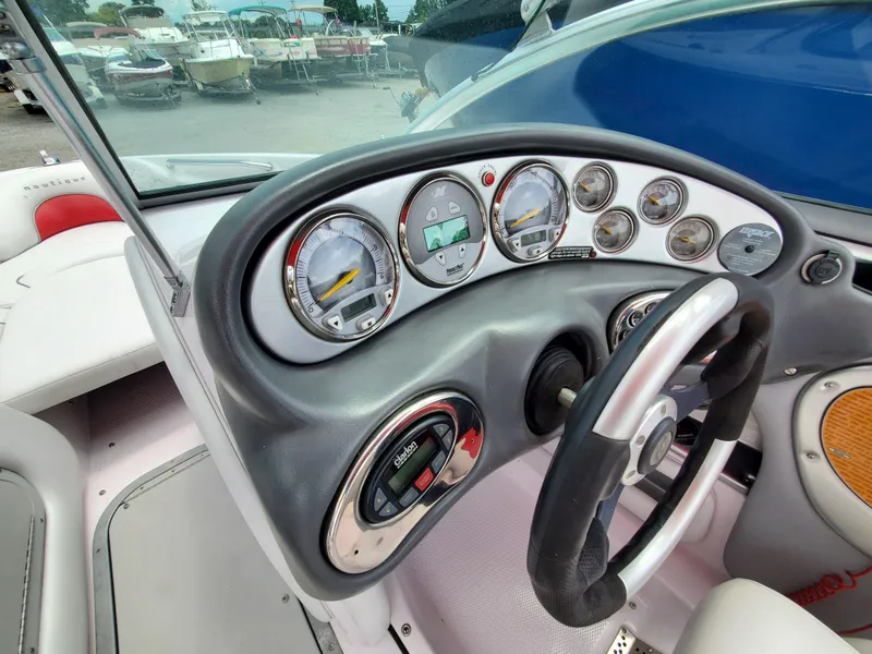 Slide: The Image of 2005 Correct Craft SV-211 Limited boat dashboard with gauges and steering wheel. - 19