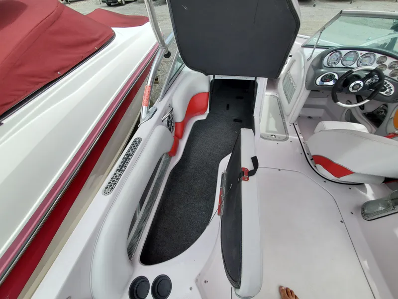 Slide: The Image of 2005 Correct Craft SV-211 Limited boat interior with open storage compartment. - 22