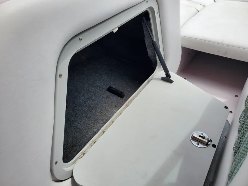 Slide: The Image of 2005 Correct Craft SV-211 Limited storage compartment with open hatch, showcasing interior space. - 26