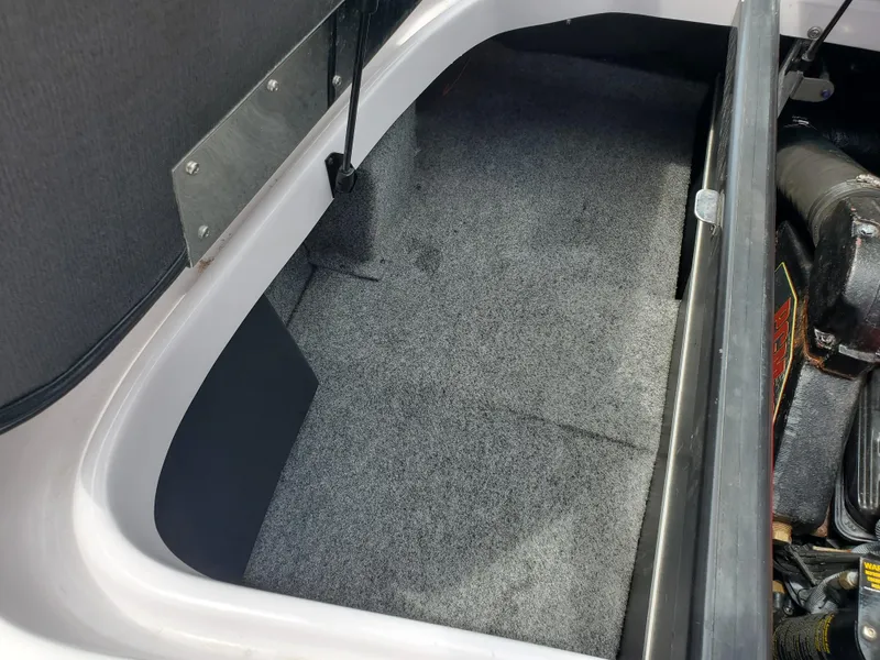 Slide: The Image of 2005 Correct Craft SV-211 Limited storage compartment with carpeted interior. - 34