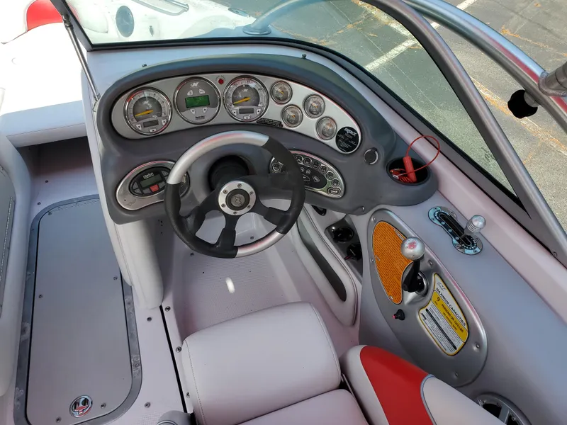 Slide: The Image of 2005 Correct Craft SV-211 Limited boat dashboard with steering wheel and control panel. - 37