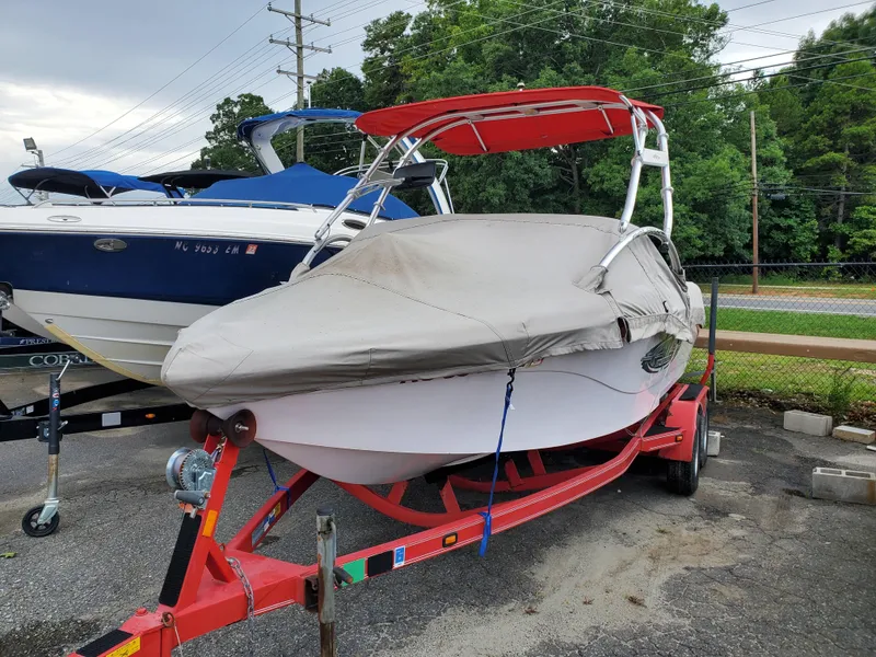 Slide: The Image of 2005 Correct Craft SV-211 Limited boat on red trailer, covered and parked outdoors. - 5