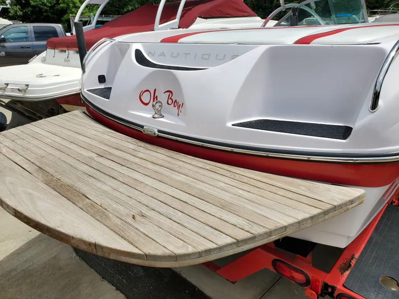 Slide: The Image of 2005 Correct Craft SV-211 Limited boat with wooden swim platform and "Oh Boy" text. - 8