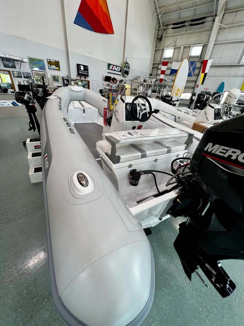 Slide: The Image of 2023 AB Inflatables Alumina 16 ALX boat displayed in a showroom. - 2