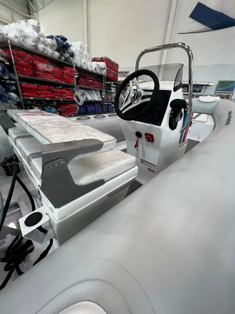 Slide: The Image of 2023 AB Inflatables Alumina 16 ALX boat interior with steering console and seating. - 5