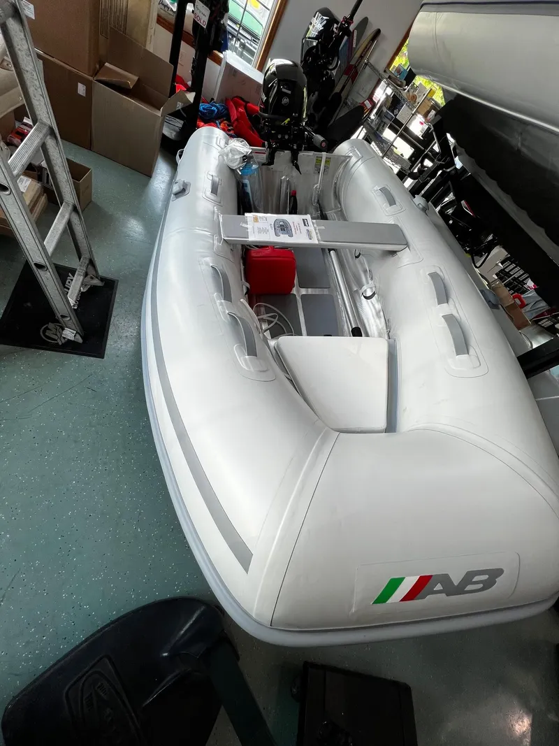 Slide: The Image of 2023 AB Inflatables Lammina 9 AL inflatable boat in a showroom. - 2