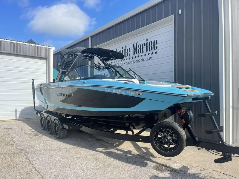 Slide: The Image of 2022 MasterCraft X26 boat on a trailer outside Dockside Marine. - 1