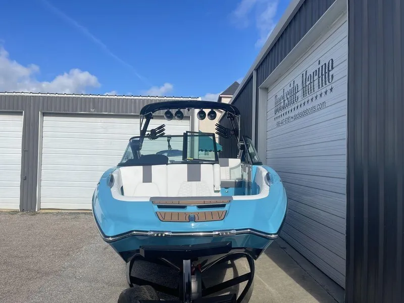 Slide: The Image of 2022 MasterCraft X26 boat in blue and white, parked at Dockside Marine. - 2